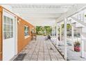 Covered patio with tiled flooring, brick accents, and ample space for outdoor activities at 13116 Boca Ciega Ave, Madeira Beach, FL 33708