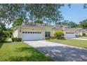Beautiful single-story home featuring a two-car garage and lush green lawn at 1188 Royal Blvd, Palm Harbor, FL 34684