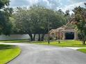 Landscaped single-story home featuring a symmetrical front facade and a lush green lawn at 7190 Raymond Pl, Spring Hill, FL 34607