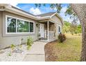 Inviting front porch with stone accents and a cozy walkway at 2204 Krista Ln, Brandon, FL 33511