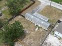 Aerial view of a home with a fenced yard, offering privacy and outdoor space at 9202 Teak St, New Port Richey, FL 34654