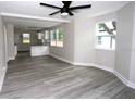Open-concept living room with new flooring and plenty of natural light, flowing into the kitchen at 5117 16Th Ave, Gulfport, FL 33707