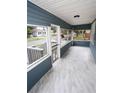 Inviting screened front porch with tile floors, providing a relaxing outdoor space at 5117 16Th Ave, Gulfport, FL 33707