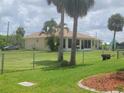 Spacious, fenced backyard offering privacy and plenty of room for outdoor activities and relaxation at 4611 Herman Cir, Port Charlotte, FL 33948
