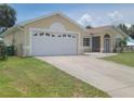 Charming single-story home featuring a two-car garage, well-kept lawn, and inviting curb appeal at 4611 Herman Cir, Port Charlotte, FL 33948