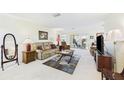 Cozy living room featuring comfortable seating, classic decor, and abundant natural light from sliding glass doors at 6948 W Country Club N Dr, Sarasota, FL 34243