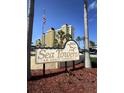 Sea Towers sign marking the entrance to this adult community, framed by palm trees and an American flag at 4750 Cove Cir # 502, St Petersburg, FL 33708