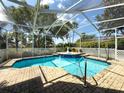 View of the screened pool with brick pavers at 1052 Archway Dr, Spring Hill, FL 34608