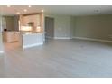 Spacious living room showcases a modern kitchen with white cabinets and a breakfast bar at 13639 Salinas St, Venice, FL 34293