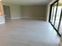 Bright living room features tile flooring and large sliding glass doors leading to the backyard at 13639 Salinas St, Venice, FL 34293