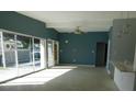 Spacious living room with an open layout, plenty of natural light, and modern ceiling fan at 21970 Cellini Ave, Port Charlotte, FL 33952