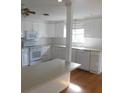 Open kitchen with ample counter space, white cabinetry, and modern appliances at 3536 Harbor Blvd, Port Charlotte, FL 33952