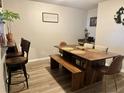 Dining area with a large wooden table, bench, and barstool seating at 3433 Dragon View Ct, Valrico, FL 33594