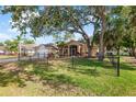 Charming single-story home with a well-maintained lawn and mature trees at 23338 Duchess Ave, Port Charlotte, FL 33954