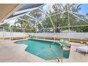 Inviting screened-in pool area, perfect for relaxation and entertainment at 23338 Duchess Ave, Port Charlotte, FL 33954