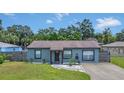 Quaint gray house with a fenced yard and driveway at 4308 S Trask St, Tampa, FL 33611