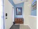 Bright entryway with blue walls and wood storage at 10507 Goldwater Ln, Riverview, FL 33569
