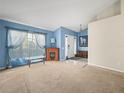 Living room with blue walls, carpet, and fireplace at 10507 Goldwater Ln, Riverview, FL 33569