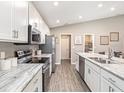 Modern kitchen with white cabinets and granite countertops at 2560 58Th E Cir, Palmetto, FL 34221