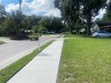Quiet residential street with sidewalks and mature trees at 6704 N 13Th St, Tampa, FL 33604