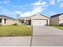 New construction home with a two-car garage and spacious driveway at 35591 Bellington Blvd, Zephyrhills, FL 33541