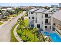 Back exterior of modern home showcasing pool and landscaping at 116 Wimbledon Ct, Redington Shores, FL 33708
