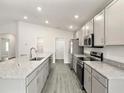 Modern kitchen boasting stainless steel appliances, granite countertops, and an abundance of cabinet storage at 7011 161St E Ter, Parrish, FL 34219