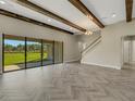 Spacious living area featuring herringbone floors and sliding glass doors at 10469 Meadowrun Dr, Lithia, FL 33547