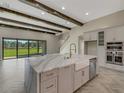 Gourmet kitchen with island, stainless steel appliances, and white quartz countertops at 10469 Meadowrun Dr, Lithia, FL 33547