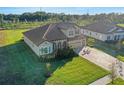 Two story house, tile roof and driveway, next to other homes at 10469 Meadowrun Dr, Lithia, FL 33547