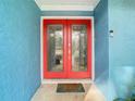 Eye-catching red double front doors with glass inserts at 8613 Beth Ct, Odessa, FL 33556