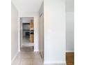 Hallway with tile floors and view of the kitchen at 8613 Beth Ct, Odessa, FL 33556