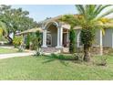 Beautifully landscaped home exterior with mature trees and shrubs enhancing its curb appeal and welcoming entrance at 2638 E Knights Griffin Rd Rd, Plant City, FL 33565
