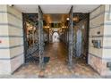 Entrance to a building with ornate metal gates and tile flooring at 405 Central Ave # 210, St Petersburg, FL 33701