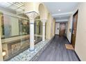 Hallway with hardwood floors, columns, and a view of the interior courtyard at 405 Central Ave # 210, St Petersburg, FL 33701