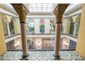 View of a building's interior courtyard with glass ceiling, ornate columns, and tile floors at 405 Central Ave # 210, St Petersburg, FL 33701