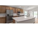 Stylish kitchen featuring stainless steel appliances, a large island, and ample cabinet space at 6929 161St E Ter, Parrish, FL 34219