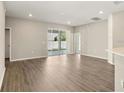 Spacious living room featuring wood floors and sliding glass doors to the backyard at 2634 58Th E Cir, Palmetto, FL 34221
