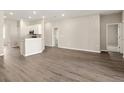 Open-concept living room and kitchen with stainless steel appliances and wood floors at 2634 58Th E Cir, Palmetto, FL 34221