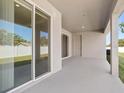 Covered patio with sliding glass doors, perfect for outdoor dining and entertainment at 2634 58Th E Cir, Palmetto, FL 34221
