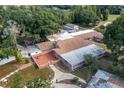 Aerial view of home, showcasing large backyard and outbuildings at 4911 W Sam Allen Rd, Plant City, FL 33565
