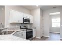 Modern kitchen with stainless steel appliances and white cabinets at 2504 58Th E Cir, Palmetto, FL 34221