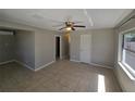 Bright bedroom featuring neutral walls, tile flooring, and a ceiling fan for added comfort at 3967 Arkansas Ne Ave, St Petersburg, FL 33703