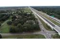 An aerial view of a property with surrounding trees and proximity to a convenient highway at 750 Charlie Taylor Rd, Plant City, FL 33566