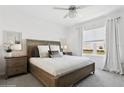 Cozy bedroom features a comfortable queen-sized bed, bright window and soft natural light at 11658 Bluestone Ct, Parrish, FL 34219