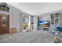 Bright living room boasts large arched window, soft gray walls, and built-in entertainment center at 530 Napa Valley Cir, Valrico, FL 33594