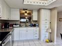 Galley kitchen features granite countertops, white cabinets, and modern fixtures at 11231 Dollar Lake Dr # 1, Port Richey, FL 34668