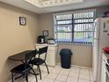 Eat-in kitchen features a dining area, a window view, and white appliances at 11231 Dollar Lake Dr # 1, Port Richey, FL 34668