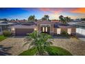 Charming exterior view of home with a circular drive and mature palm tree in yard at 5509 Pilots Pl, New Port Richey, FL 34652