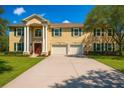 Charming two-story home with a well-kept lawn, mature trees, and a three-car garage at 11175 Hyde St, Weeki Wachee, FL 34614